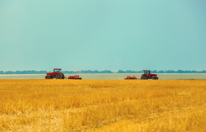 Summer Day Two Tractors To Plow, Plow the Soil on Sloping, Wheat. Stock ...