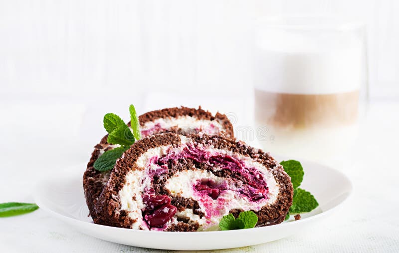 Chocolate roll cake with cream and cherries stock image