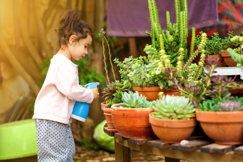 Summer Fun: Little Beautiful Girl Watering Garden. stock photos Summer Fun: Little Beautiful Girl Watering Garden. stock photos