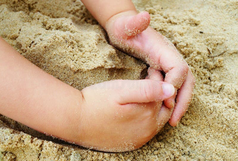 Child Playing in Sand at Beach