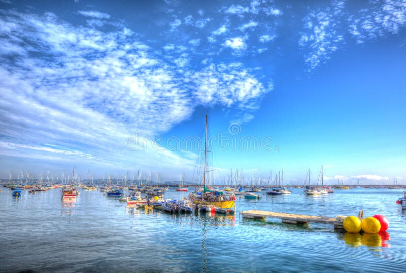 Summer 2013 heat wave Brixham Devon harbour UK with calm blue sea and sky in HDR