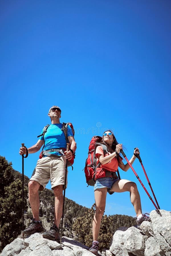 Summer hike in the mountains with a backpack and tent along the