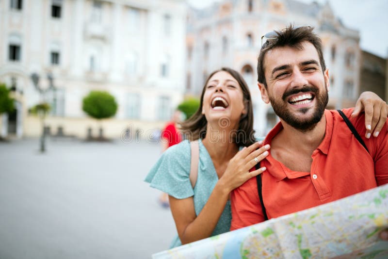 Summer holidays, dating and tourism concept. Smiling couple with map in the city