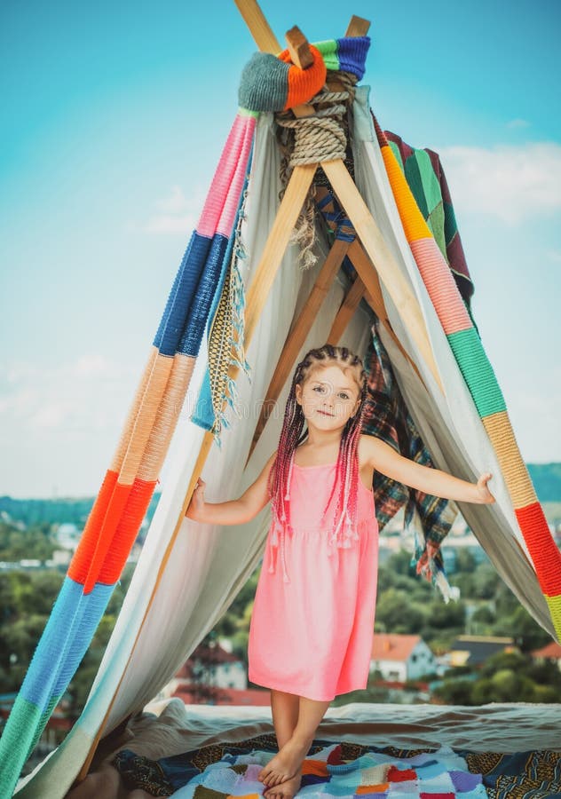 Sisters spending time in a tent on camping. Children using tablet playing games  online during summer vacation - a Royalty Free Stock Photo from Photocase