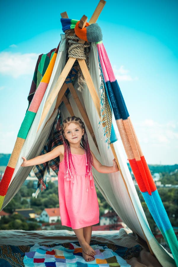 Sisters spending time in a tent on camping. Children using tablet playing games  online during summer vacation - a Royalty Free Stock Photo from Photocase