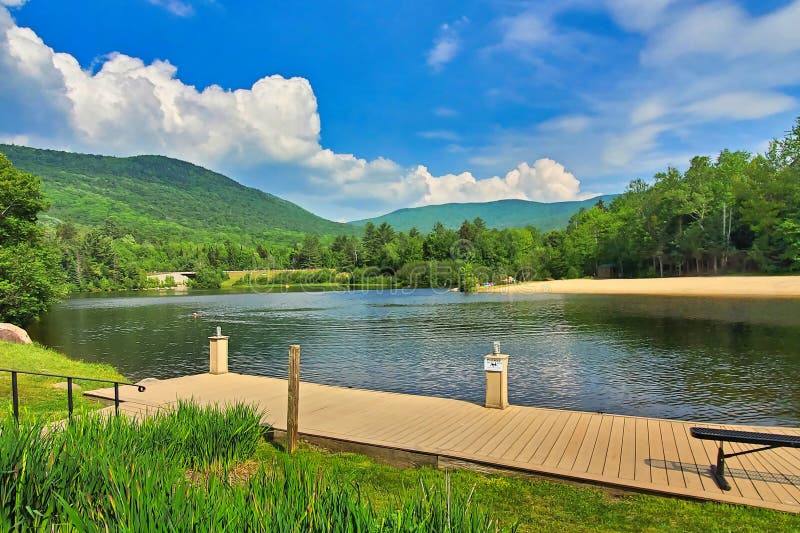 Summer landscape of swimming lake and mountain background stock photography