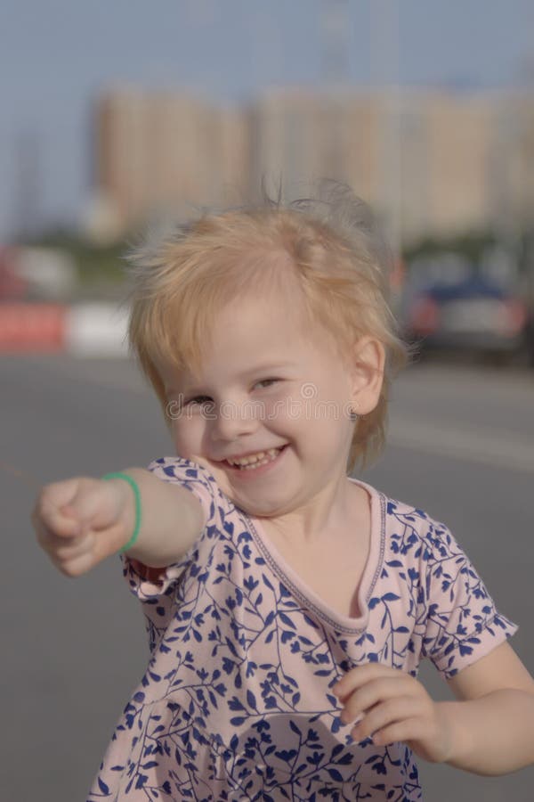 Summer a little girl is guessing on a Daisy stock photo Summer a little girl is guessing on a Daisy stock photo