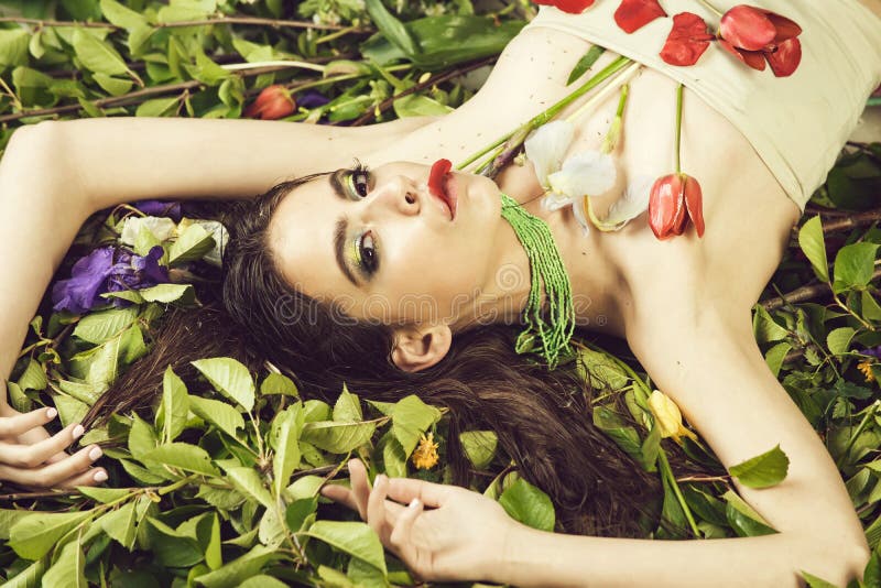 Summer Make Up. woman with fashionable makeup with flowers on green leaves royalty free stock image Summer Make Up. woman with fashionable makeup with flowers on green leaves royalty free stock image