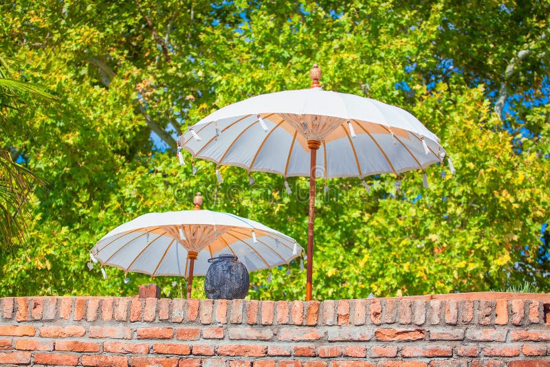 White umbrellas and wall stock image. Image of shadow 127281261