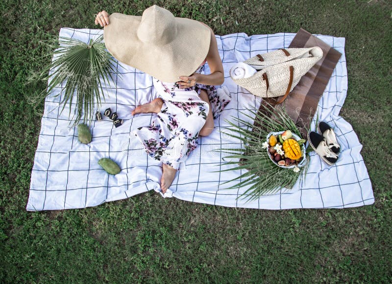 Summer picnic, girl with a plate of fruit.