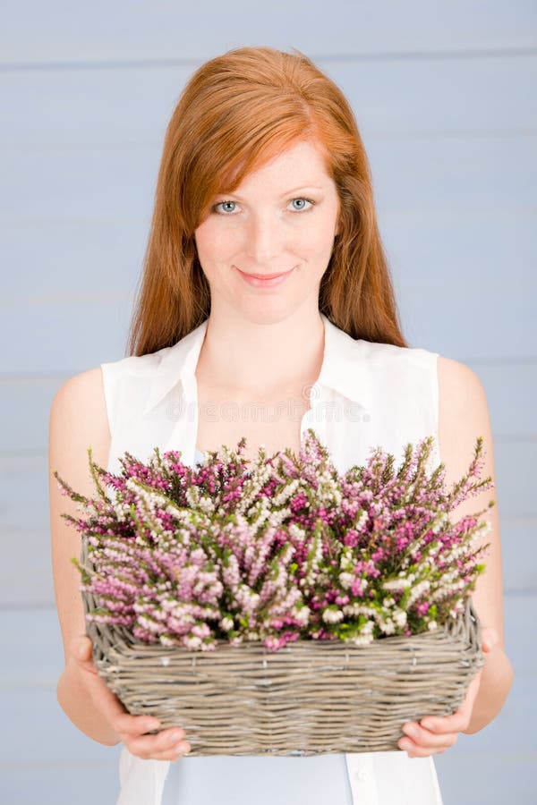 Summer redhead woman hold basket with flowers royalty free stock image Summer redhead woman hold basket with flowers royalty free stock image
