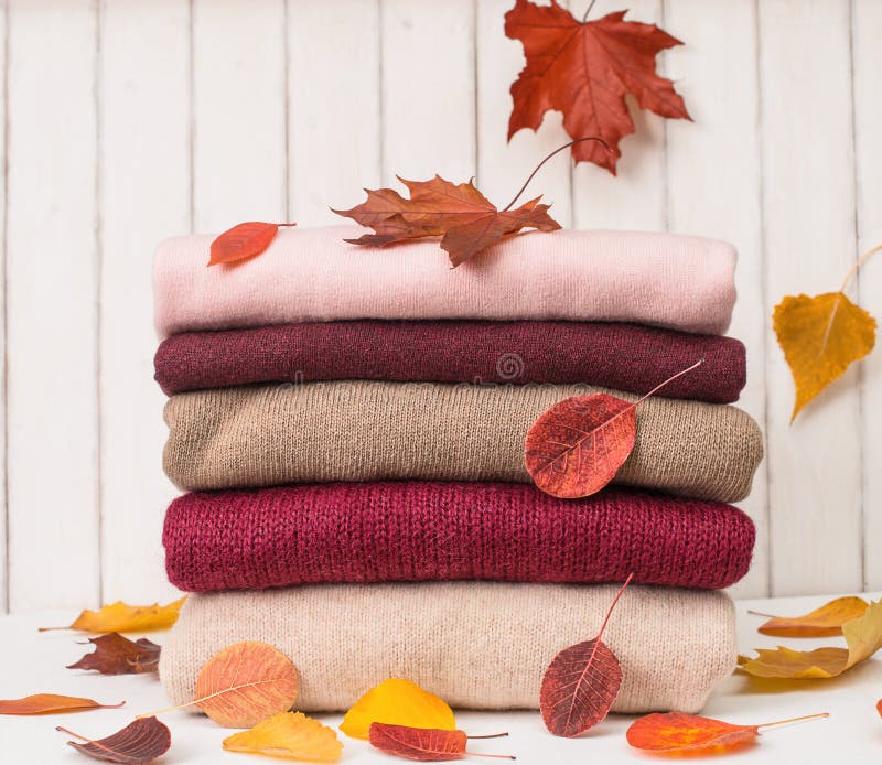 Background of of knitted woolen clothes with autumn leaves. Autumn sales. Knitted texture. Winter woolen clothes stock images, royalty-free photos and pictures