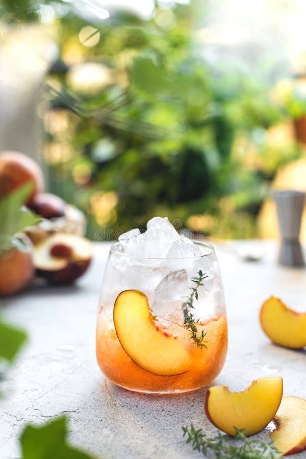 Summer Refreshing Ice Cocktail with Peach Slice and Thyme Stock Image