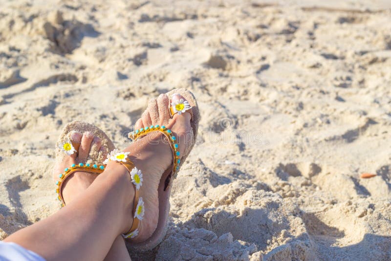 Female Feet in Sandals Laying on Golden Sand on the Beach. Relaxation ...