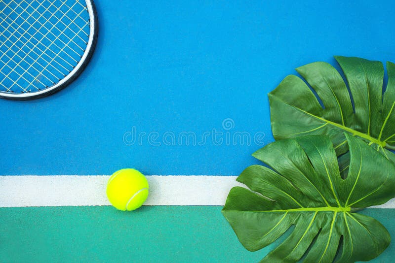 Summer Sport Concept With Green Monstera Leaf And Tennis Ball, Racquet On White Line On Hard Tennis Court