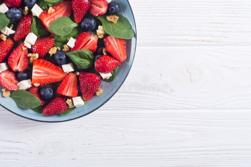 Summer Strawberry salad with spinach , cheese , nuts and blueberry stock photography Summer Strawberry salad with spinach , cheese , nuts and blueberry stock photography