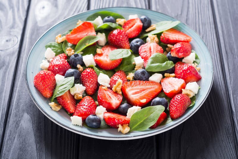 Summer Strawberry salad with spinach , cheese , nuts and blueberry royalty free stock photo Summer Strawberry salad with spinach , cheese , nuts and blueberry royalty free stock photo