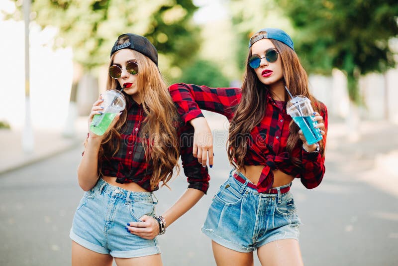 Two teen girl friends together having fun. Outdoors, urban lifestyle. Toned. Two teen girl friends together having fun. Outdoors, urban lifestyle. Toned.