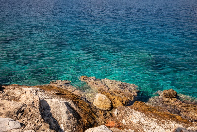 Summer sunny day crystal clear turquoise water and rocky coast of the beautiful Aponissos bay, Agistri island, Saronic Gulf