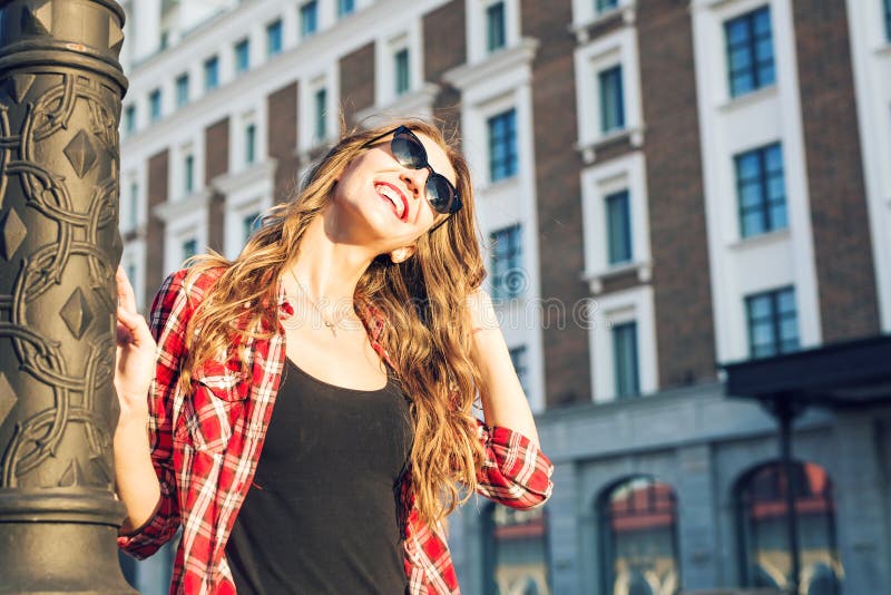 Summer sunny lifestyle fashion portrait of young stylish hipster woman walking on the street, wearing cute trendy outfit stock photography Summer sunny lifestyle fashion portrait of young stylish hipster woman walking on the street, wearing cute trendy outfit stock photography