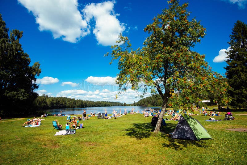 Norrkoping, Sweden - August 4, 2013: People enjoying a sunny day by lake Sorsjon. Norrkoping, Sweden - August 4, 2013: People enjoying a sunny day by lake Sorsjon.