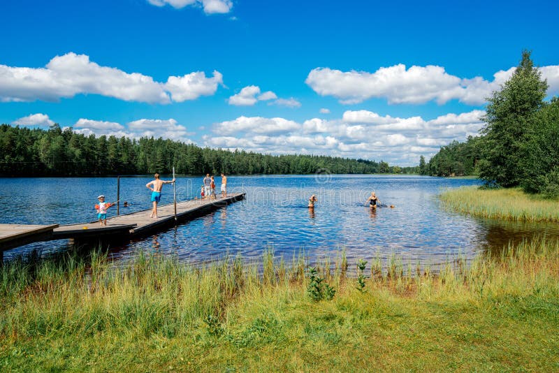 Norrkoping, Sweden - August 4, 2013: People enjoying a sunny day by lake Sorsjon. Norrkoping, Sweden - August 4, 2013: People enjoying a sunny day by lake Sorsjon.