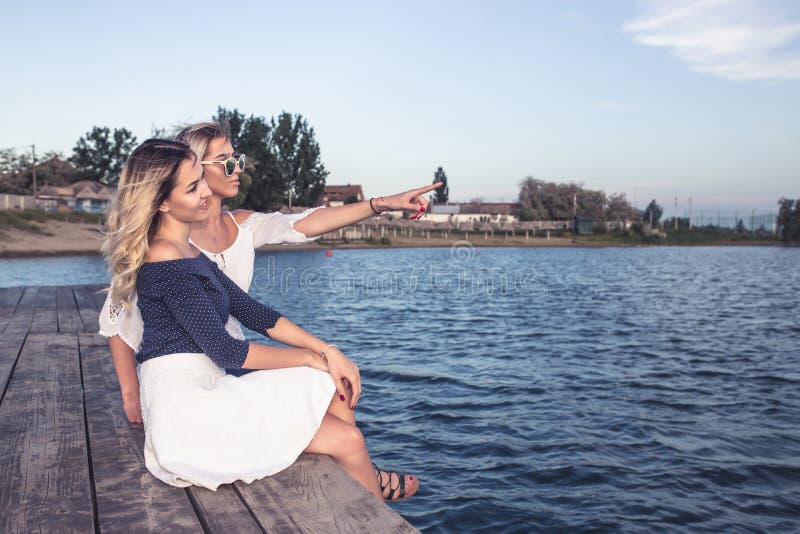 Beautiful young girls enjoying next to river stock photo Beautiful young girls enjoying next to river stock photo