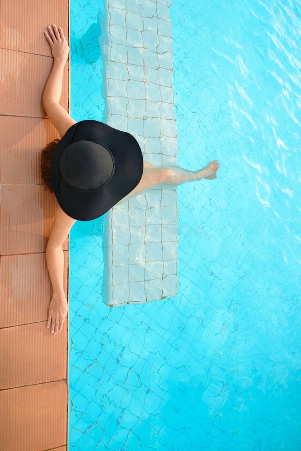 Summer time and Vacations. Women lifestyle relaxing and happy in luxury swimming pool outdoor, summer day at the beach resort in the hotel. Summer Concept