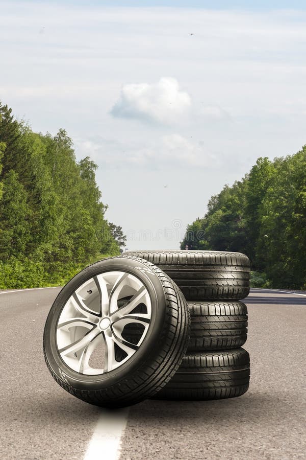 summer tires and alloy wheels set on an asphalt road. tire change season, auto trade, copy space , . auto tuning and