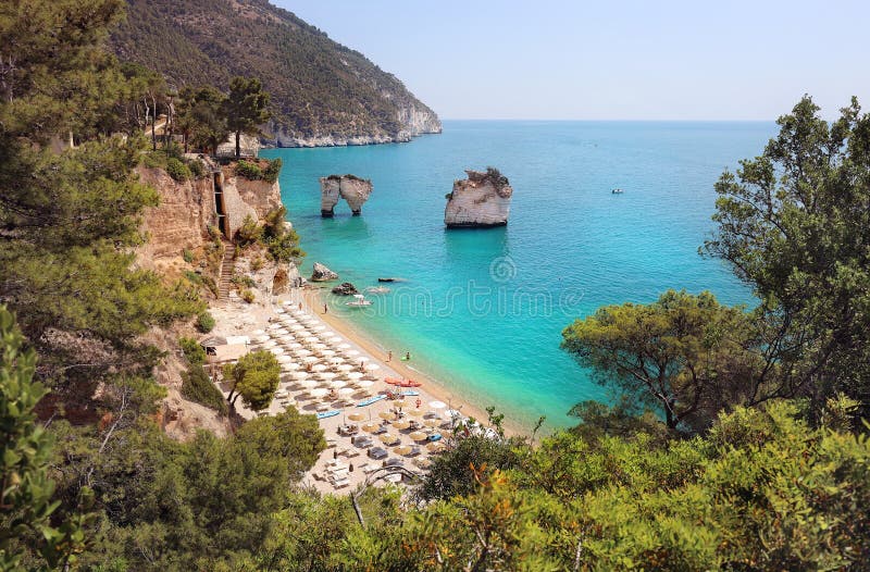 Summer touristic destination in Puglia, Italy: Faraglioni di Puglia Baia delle Zagare. Travel Italy royalty free stock photo Summer touristic destination in Puglia, Italy: Faraglioni di Puglia Baia delle Zagare. Travel Italy royalty free stock photo