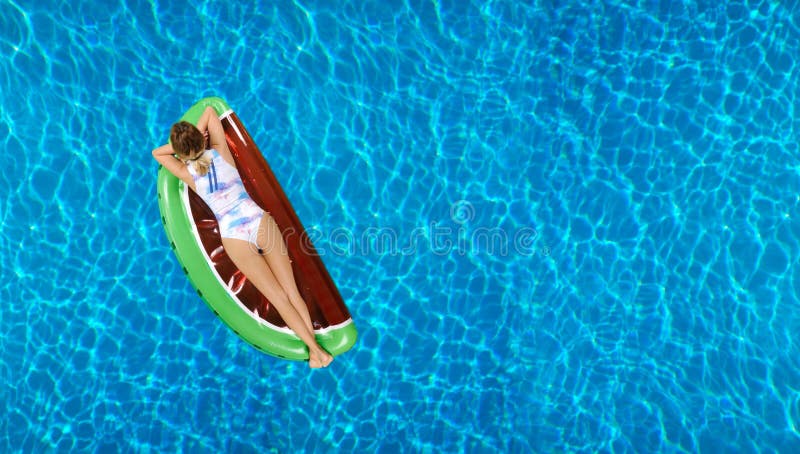 Woman in bikini on the inflatable mattress in the swimming pool. stock photography Woman in bikini on the inflatable mattress in the swimming pool. stock photography