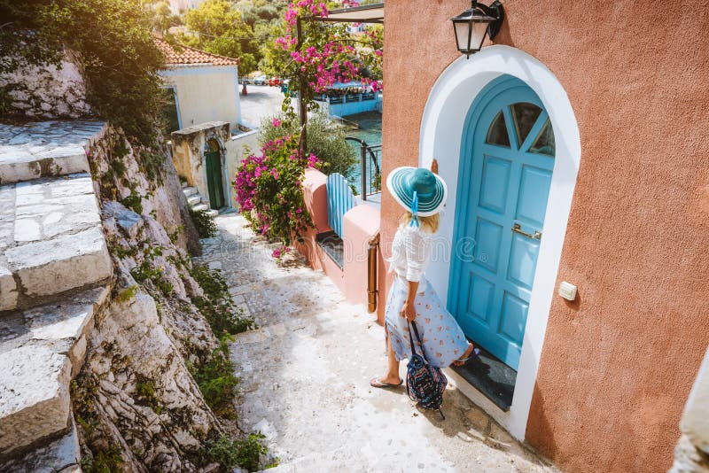 Summer vacation holiday. Travel tourist woman on vacation in Greece. Traditional Mediterranean house. Colored houses