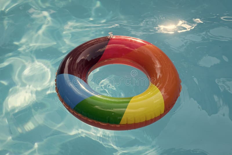 Summer vacation and travel to ocean, Bahamas. Maldives or Miami beach. Relax in spa luxury swimming pool. colorful swim ring or lifebuoy. inflatable ring float in pool blue water.