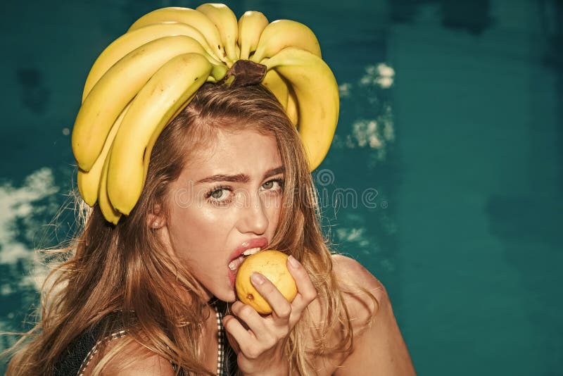 Summer vacation and travel to ocean. woman with tropical fruit in pool. Vitamin in banana at girl near water