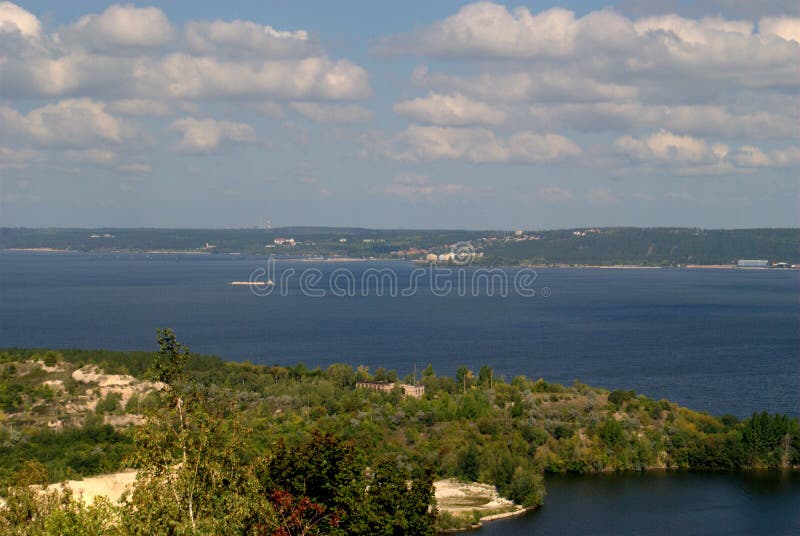 Summer view from the mountain Otvazhnaya on the Volga River and high-rise buildings of the city of Togliatti on the opposite bank. stock image Summer view from the mountain Otvazhnaya on the Volga River and high-rise buildings of the city of Togliatti on the opposite bank. stock image