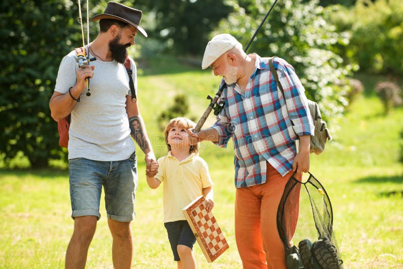 Summer weekend. Happy grandfather, father and grandson with fishing rods. Anglers. Men day. Fishing.