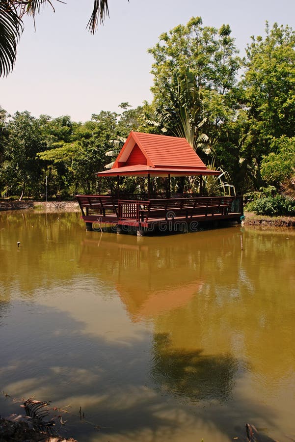 Summerhouse on the pond side. Thai style architecture and garden royalty free stock images