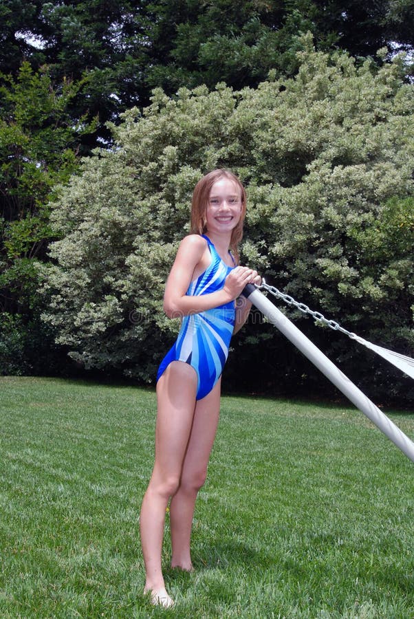 Young girl in her backyard in swim suit. Young girl in her backyard in swim suit.