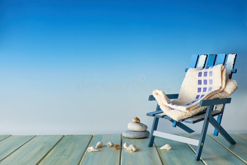 Beach chair on wooden terrace with sea shells, seaside decorations, copy-space on blue background stock images Beach chair on wooden terrace with sea shells, seaside decorations, copy-space on blue background stock images