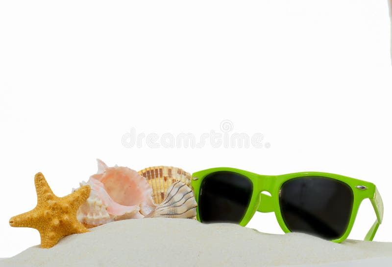 Summertime lower border image of starfish, shells and bright green sunglasses piled on sand. Isolated on white.