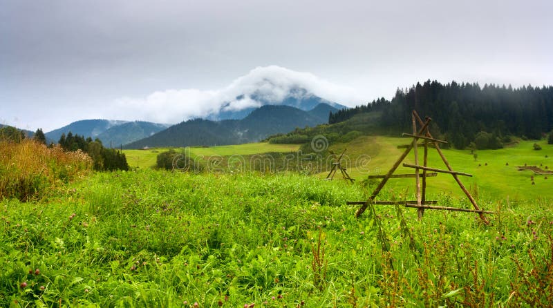 Summertime rural landscape with view at covered with white clouds mount Velky Choc Great Choc in the Slovakia