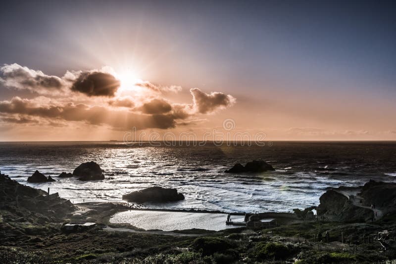 Sun bursting from behind clouds, Lands End, San Francisco, California