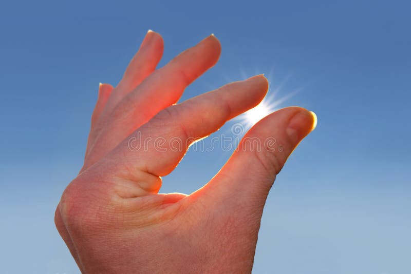Sun between Fingers of a Hand Stock Photo Image of finger, magic