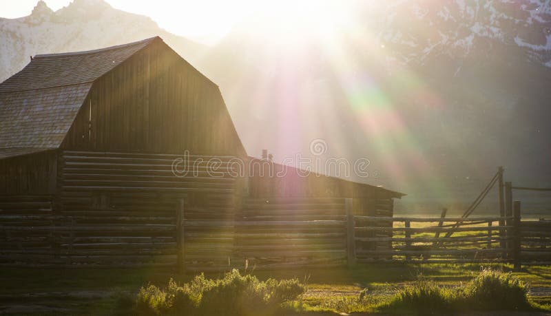 Sun flairs falling on historical antique barn