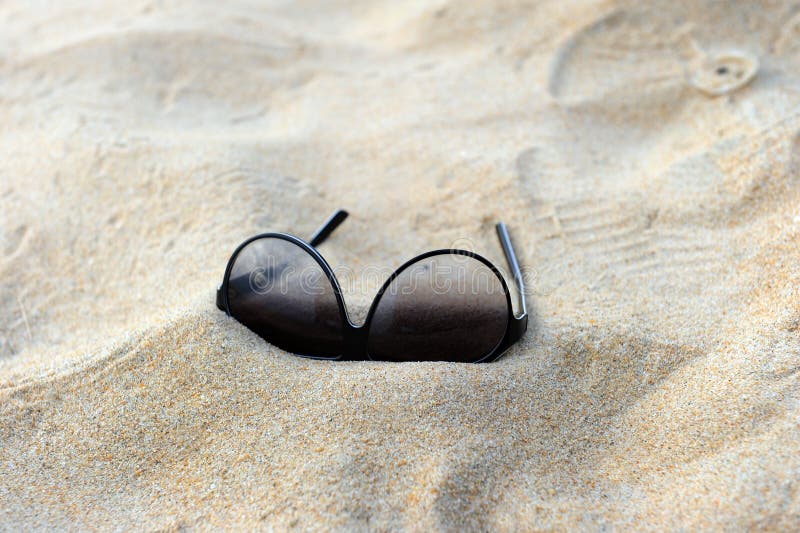 Sun glasses on sand