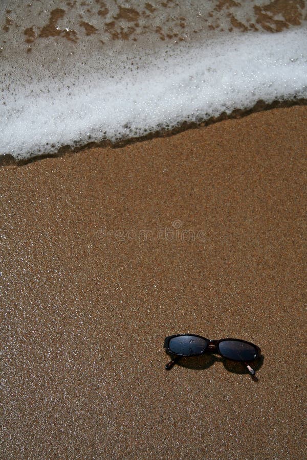 Sun glasses in the sand at the beach