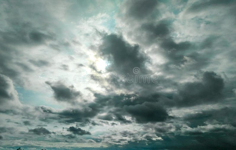 Sun Hiding Behind the Dark Black Clouds Over the Blue Sky, Dramatic Sky,  Atmospheric Moods and Bad Weather Background Stock Image - Image of  dramatic, moods: 167169761