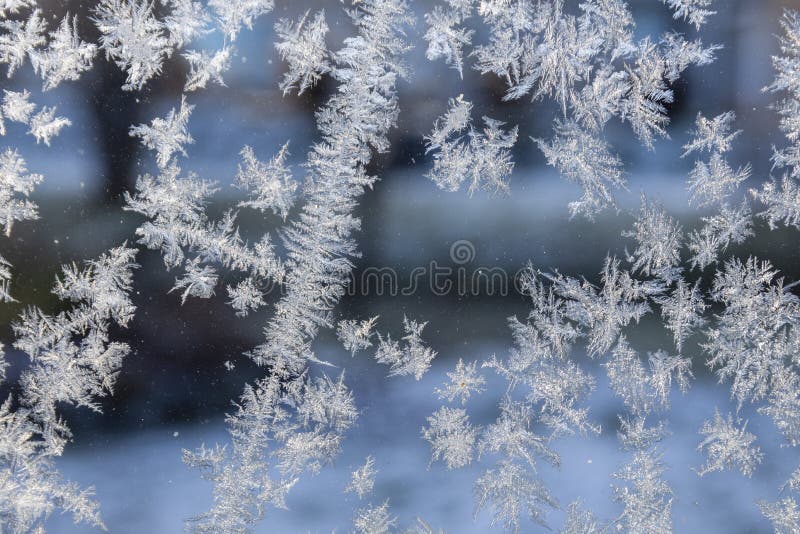 Sun illuminated frost created pattern on window royalty free stock photography