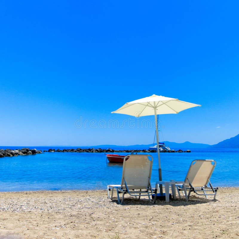 Sun Lounger and Parasol on a Beach