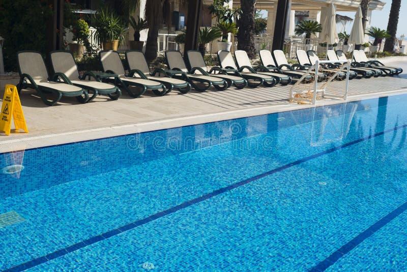 Sun Loungers Inviting To Relaxation And Rest Near To An Pool Stock